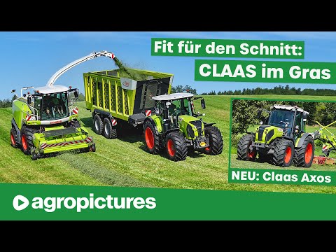 New Claas tractors in use during forage harvesting with mower, tedder, rake and Fliegl Cargos.