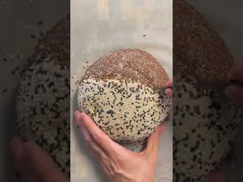 50% whole wheat sourdough loaf with 83% hydration and a coating of flax, sesame, and nigella seeds