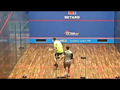 SQUASH. Backhand top-spin drop.