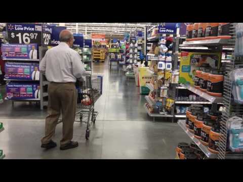 Zuhair playing with vacuum at Walmart with Abu Daado and Baba