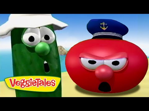 Green cucumber character with a white hat and surprised expression beside a red tomato character wearing a captain's hat on a beach, VeggieTales logo visible.