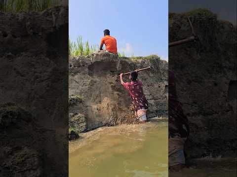 The man was sitting above the river.