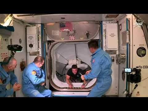 SpaceX Demo 2 crew opens hatch and enters space station.