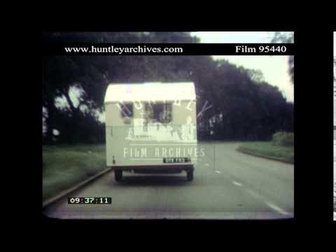 1950's following a caravan on a British road.  Archive film 95440
