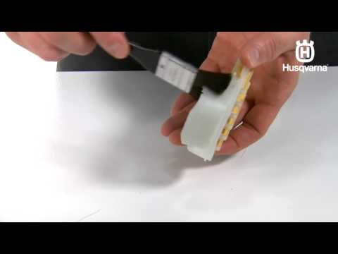 Part of a video titled How to Clean an Air Filter in a Husqvarna Chainsaw - YouTube