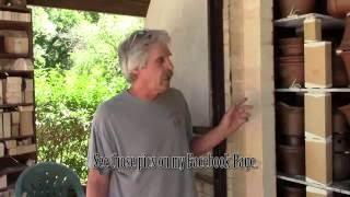 Removing the skim coat on the wood kiln door.