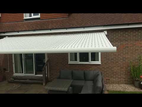 Markilux MX-3 patio awning with smart art fabric cover and spreader brackets