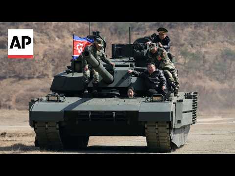 North Korean leader Kim and daughter ride tank together during army training
