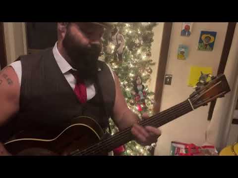 Rev. Peyton plays Silent Night and Jingle bells on the old National guitar