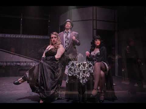 Adrift in Macao trailer frame with chorus in trench coats in a foggy nightclub