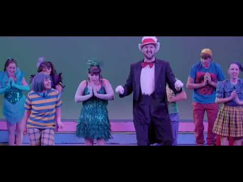 Seussical trailer image: colorful company in Seussian costumes, Cat in the Hat center stage