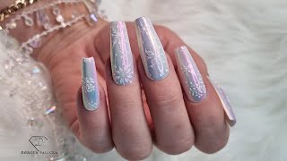 Glazed chrome nails with snowflakes. January frozen nails 
