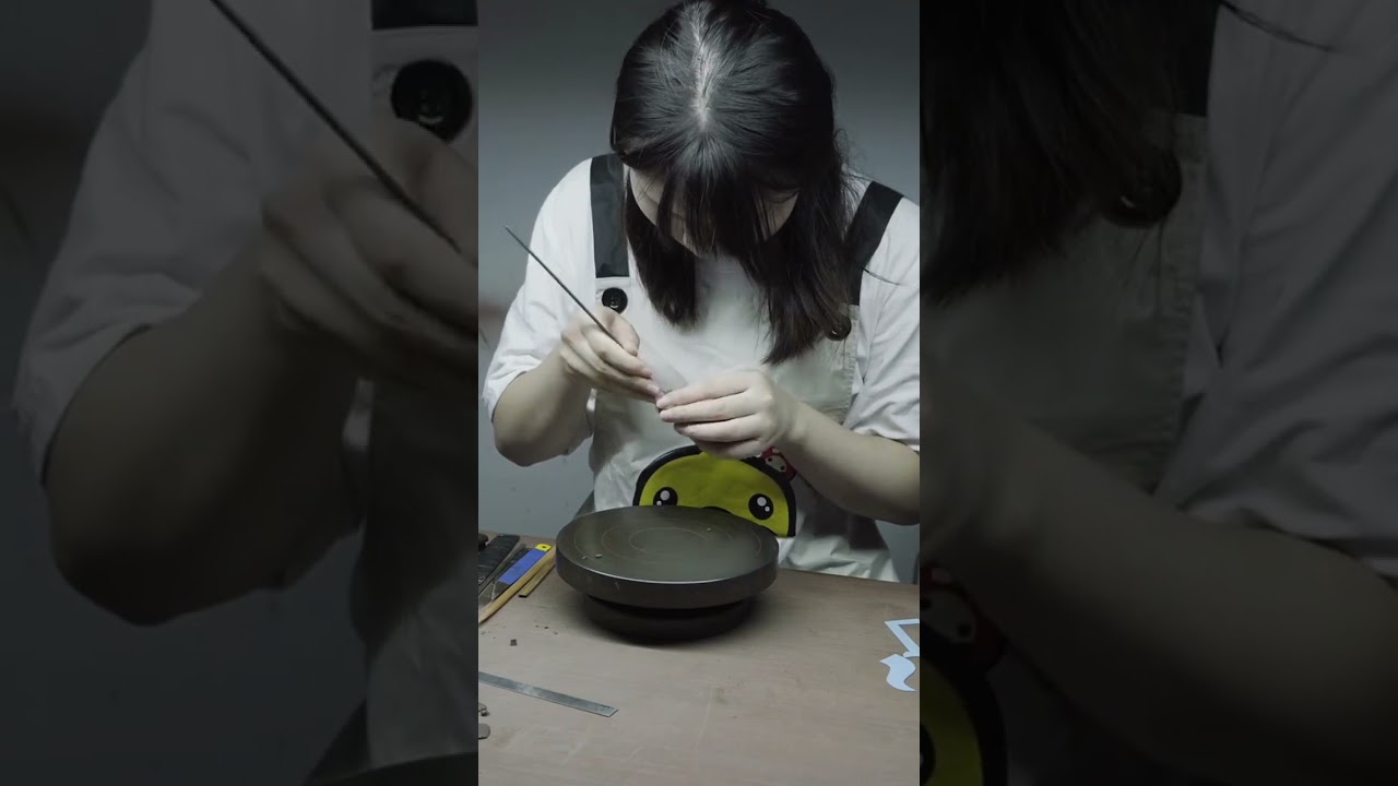 A female master creates a stunning Zisha teapot. The attention to details is simply amazing. 