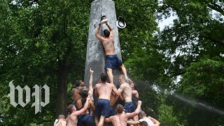 Hundreds of Naval Academy plebes climb monument