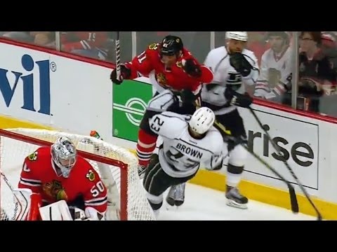 Marian Hossa flattens Brown behind the net