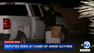 Deputies carrying boxes from  home of Annie Guthrie, sister of 'Today' co-anchor