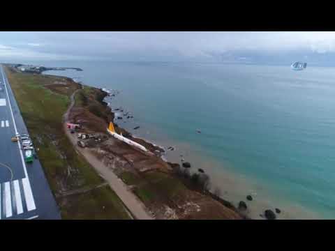 PLANE SKIDS OF RUNWAY AND GETS STUCK AT SLOPE END