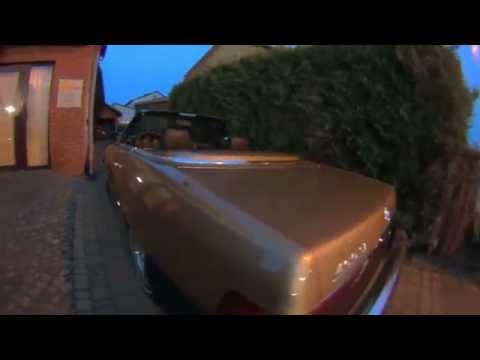 Mercedes 450SL with radio in rearview mirror.