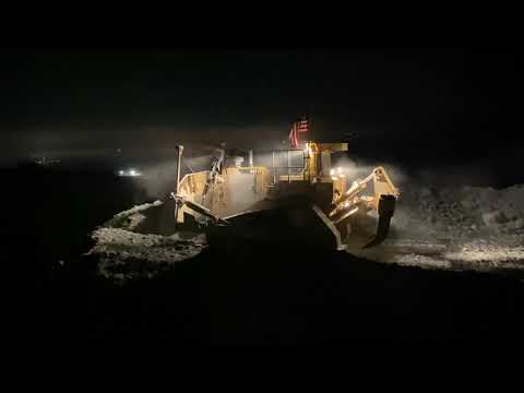 Caterpillar D8T pushing rock in quarry