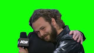 Jack Perry & Tony Khan hugging green screen