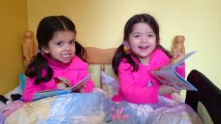 Twin sisters singing nursery rhymes together