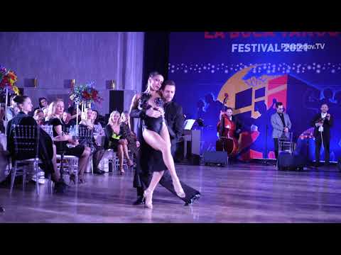  Olga Nikola  and  Dmitriy Kuznetsov  are  dancing  to  a  nontraditional song  at  La Boca Tango Festival  in  2021