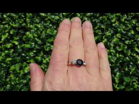 A three stone sapphire and diamond ring