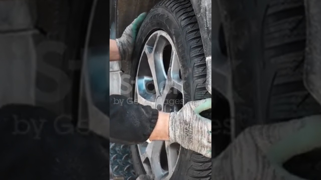Tire man changing tires in workshop 4K stock video...