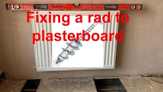 INSTALLING A RADIATOR ON A PLASTERBOARD WALL. How to dress and  install a radiator using pig tails