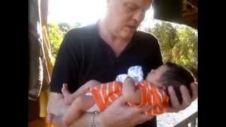 Daddy holds Baby Lily outside Home Nong Bua Lum Phu