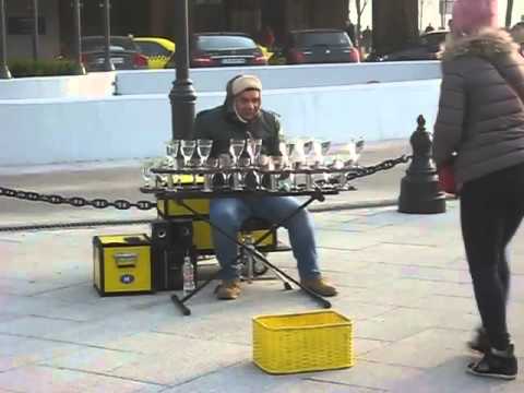 Street performer amazingly plays music on water glasses