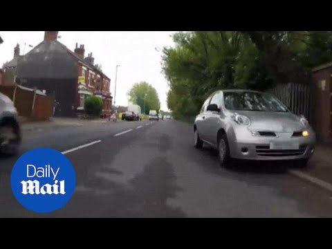 Driver passes a motorcyclist by mounting the pavement - Daily Mail