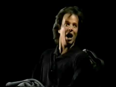 A still showing the ensemble in press-conference and tournament staging—music as political theater