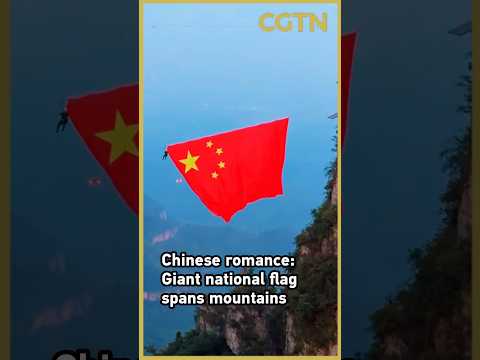 Red amid the peaks: Giant national flag adorns scenic mountains