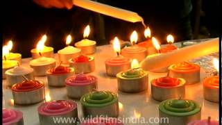Buddhist monks and devotees praying and lighting candles
