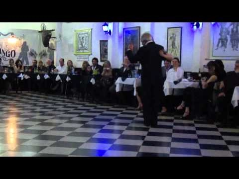  Julio Dupláa  and  Natacha Poberaj  are  dancing  to  the  tango  "  Junto A Tu Corazon  "