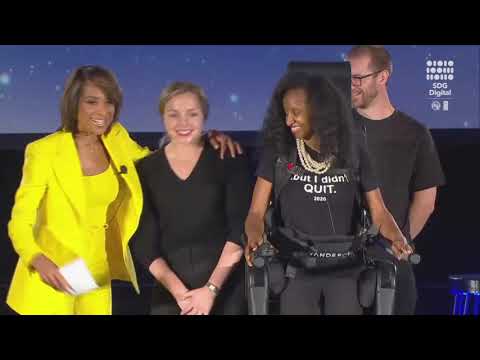 Bianca Faith Johnson, J.D., President of Push to Walk, using an exo ...