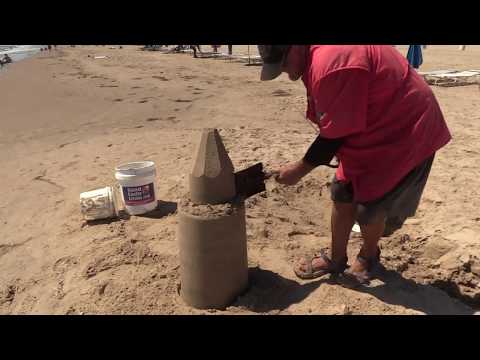Sandcastle carved with a shovel and credit card