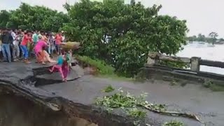 Moment villagers plunge into floodwater as bridge collapses in India