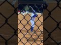 Weston driving the ball off the left field fence.