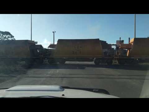 Extremely slow train cross AHOF iron ore wagons