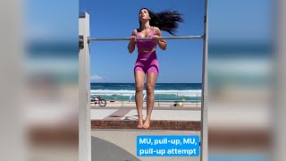 Girl does Muscle up and pull-up challenge at Bondi Beach. Calisthenics
