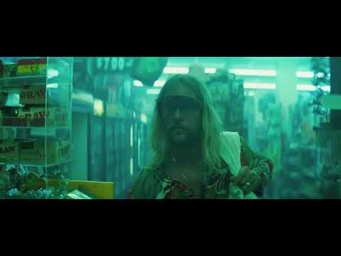 Trailer frame of The Beach Bum capturing a quiet, reflective waterfront moment