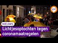 In Apeldoorn en Arnhem protesteerden mensen met lichtjes tegen de coronamaatregelen