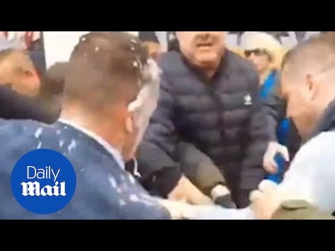 Tommy Robinson swings at protestor after being hit with milkshake