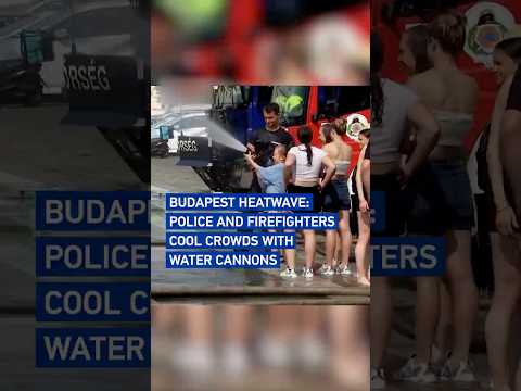 Budapest heatwave: Police and firefighters cool crowds with water cannons