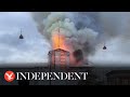 180ft spire collapses as blaze engulfs Copenhagen's 17th-century stock exchange