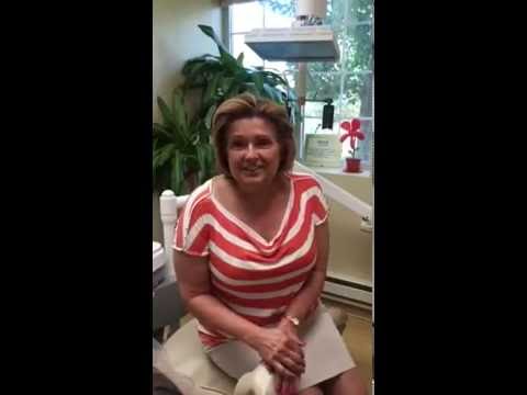 Woman in red and white striped shirt in dental office