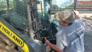 Putting the new door Back in the New Holland l230 skid loader