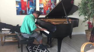 Kris Nicholson practicing on a Steinway L Grand piano